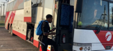 migrant getting on bus